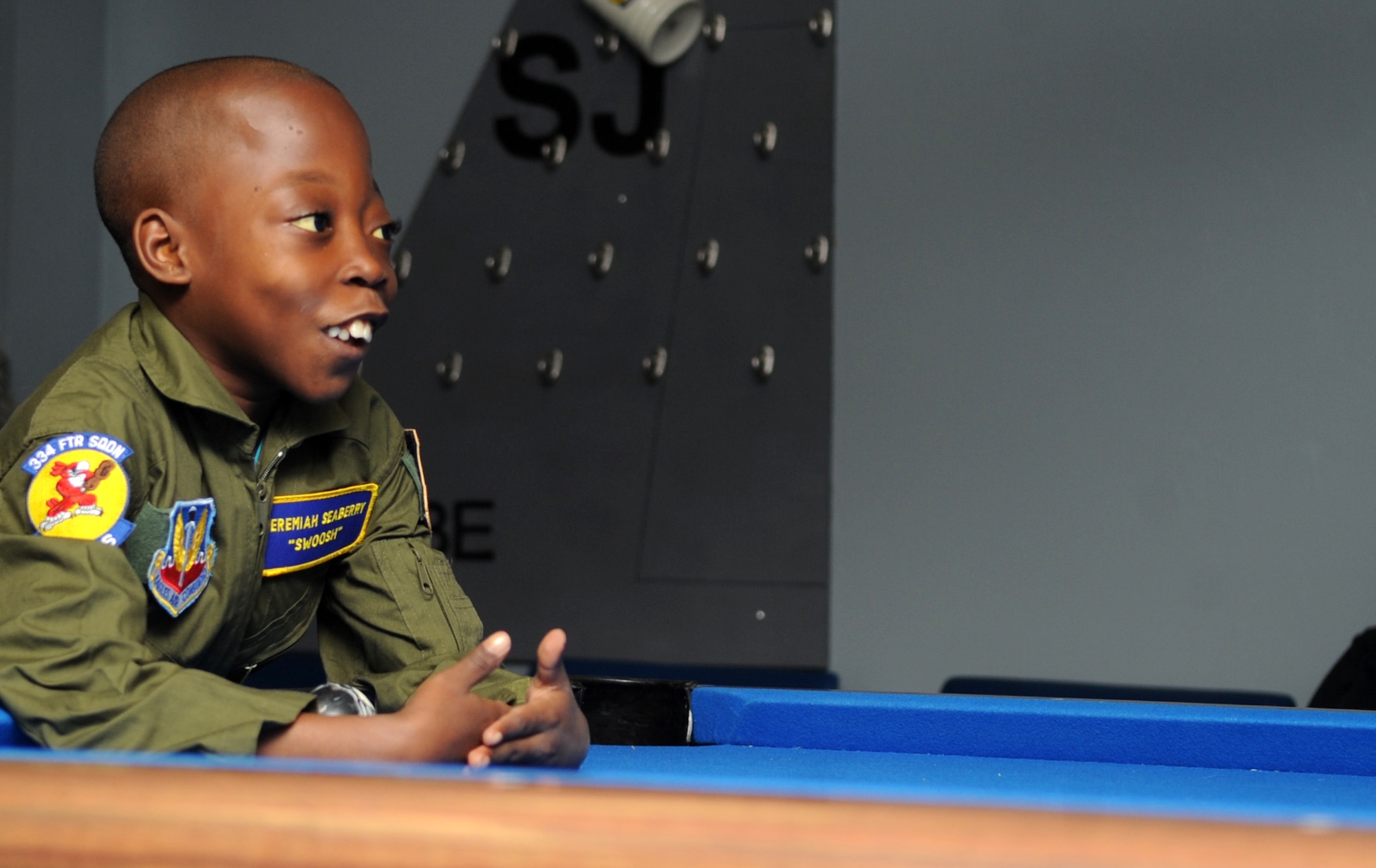 Jeremiah Seaberry, 334th FS pilot for a day, learns how to play crud from Capt. Adam Luber, 334th Fighter Squadron instructor pilot, during a 4th Fighter Wing Pilot for a Day event, April 3, 2015, at Seymour Johnson Air Force Base, North Carolina. Crud is a mix between pool and football, and was one of the many fighter pilot traditions Jeremiah  learned about during his visit to the base. (U.S. Air Force photo/Senior Airman Ashley J. Thum)