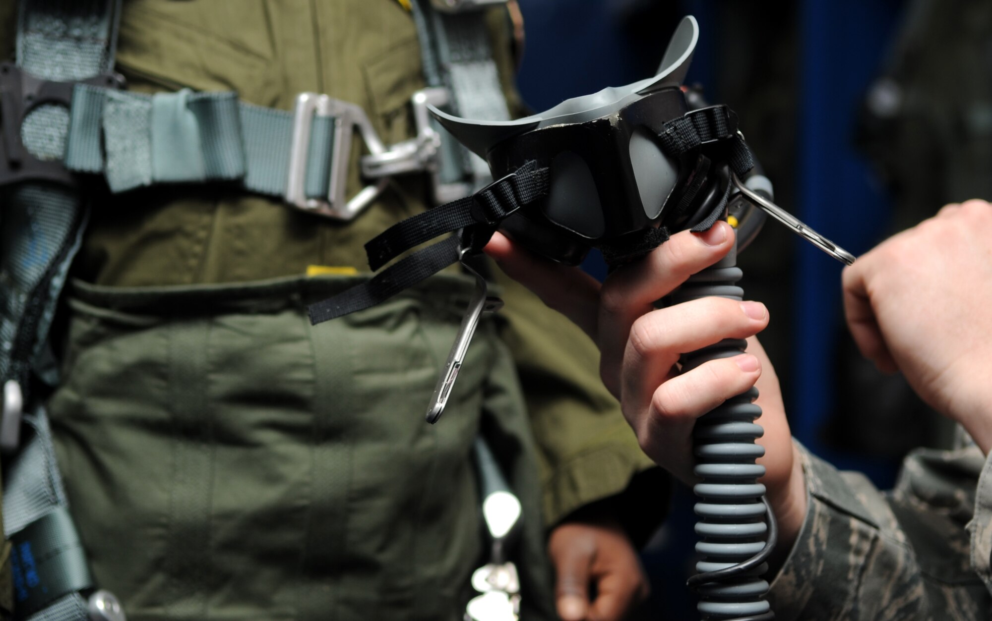 Airman 1st Class Luke Locken, 4th Operations Support Squadron aircrew flight equipment technician, adjusts the oxygen mask for Jeremiah Seaberry, 334th Fighter Squadron pilot for a day, during a 4th Fighter Wing Pilot for a Day event, April 3, 2015, at Seymour Johnson Air Force Base, North Carolina. Jeremiah was geared up with a flight suit, flight harness, G-force compression pants, helmet, gloves and an oxygen mask. (U.S. Air Force photo/Senior Airman Ashley J. Thum) 