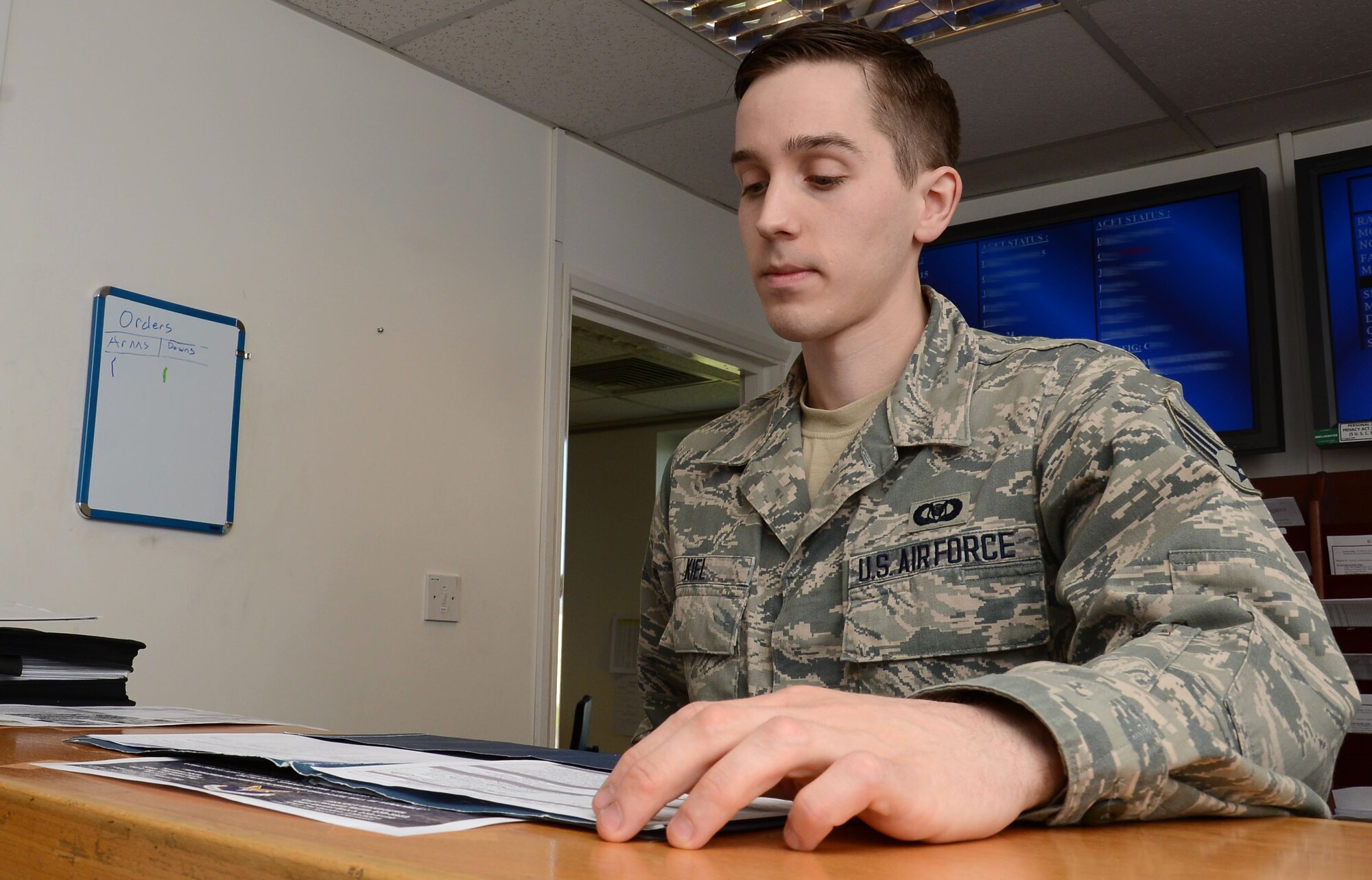 U.S. Air Force Senior Airman Nicholas Kiel, 67th Special Operations Squadron avation ressource management journeyman from Muskegon, Mich., reviews flight orders for the next day’s flight April 7, 2015, on RAF Mildenhall, England. (U.S. Air Force photo illustration by Gina Randall/Released)