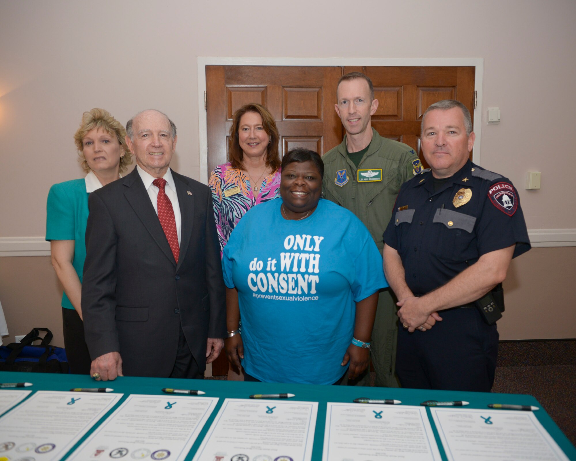 Barksdale and community partners pose for a photo on Barksdale Air Force Base, La., April 3, 2015. This is the first year local colleges and universities joined with Team Barksdale to sign the annual proclamation, which states sexual violence is widespread and impacts every person in the Shreveport-Bossier community. (U.S. Air Force photo/Senior Airman Benjamin Raughton)