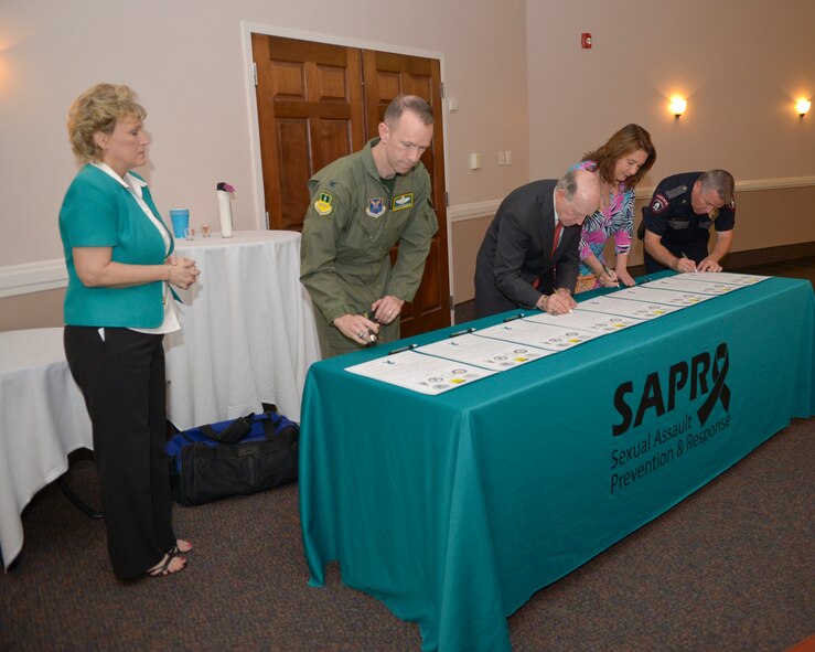 Barksdale and community leaders sign the 2015 Sexual Assault Awareness Month proclamation on Barksdale Air Force Base, La., April 3, 2015. This is the first year local colleges and universities joined with Team Barksdale to sign the annual proclamation, which states sexual violence is widespread and impacts every person in the Shreveport-Bossier community. (U.S. Air Force photo/Senior Airman Benjamin Raughton)