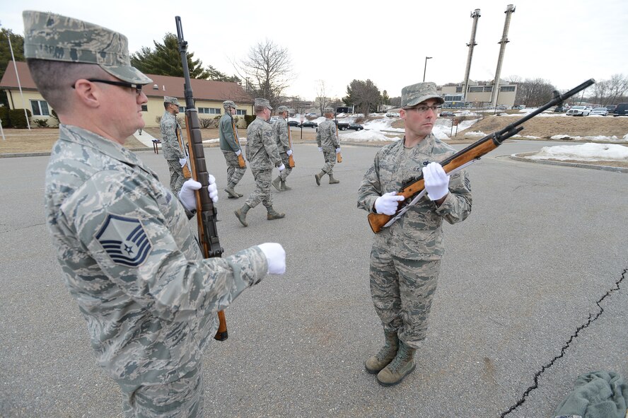 Master Sgt. Christopher DiAngelo, Patriot Honor Guard trainer, mentors Staff Sgt. Lee Shortell on the correct way to fire his weapon as part of a rifle detail during a funeral honors training exercise, Apr. 2. The Patriot Honor Guard conducts regular training to ensure that when they are called upon to conduct a military funeral, it is performed flawlessly. The honor guard team is comprised of active duty Airmen, Air National Guard and Air Force Reserve from the six New England states and New York. (U.S. Air Force photo by Jerry Saslav)