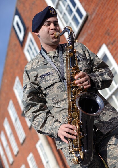 U.S. Air Force Airman 1st Class Javier Rodriguez, 100th Security Forces Squadron response force member from Rochester, N.Y., plays the alto saxophone in front of the 100th Air Refueling Wing building March 13, 2015, on RAF Mildenhall, England. Rodriguez auditioned and was selected for the 2015 Tops in Blue cast.  (U.S. Air Force photo by Senior Airman Christine Griffiths/Released)
