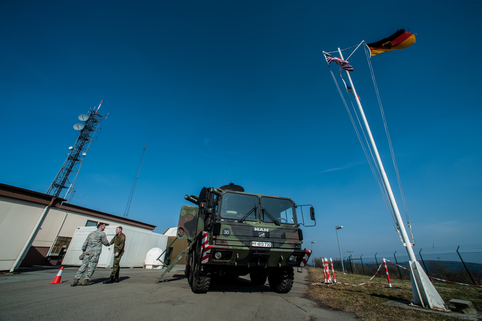 U.S. Air Force Col. Cloyce Adams, Polygone Warrior Preparation Center Detachment 3 commander, shakes hands with German army Master Sgt. Bernhard `Fledermausmann` Huetter, PWPC operator, next to a Roland surface-to-air missile at the Polygone Electronic Warfare Range in Bahn, Germany, March 18, 2015. Roland surface-to-air missiles offer a chance for pilots to train on live radar systems to prepare them for real-world scenarios. (U.S. Air Force photo/Senior Airman Nicole Sikorski)
