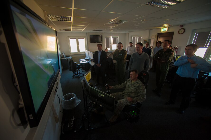 U.S. Air Force Col. Cloyce Adams, Polygone Warrior Preparation Center Detachment 3 commander, uses the Multinational Aviation Live Virtual Constructive Training System at the Polygone Control Center in Bann, Germany, March 18, 2015. The Polygone range acts as a virtual training center for pilots where they communicate with PCC operators during NATO surface-to-air exercises. (U.S. Air Force photo/Senior Airman Nicole Sikorski) 