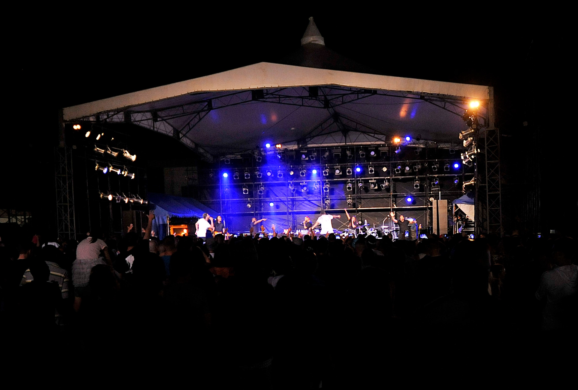 T-Pain, an American singer and rapper, and his band perform several of his hit songs during his concert on Kadena Air Base, Japan, April 6, 2015. Thousands of service members and their families came out to the Schilling Community Center parking lot for the free concert, which was put on by the 18th Force Support Squadron and Navy Morale Welfare and Recreation. (U.S. Air Force photo by Naoto Anazawa)