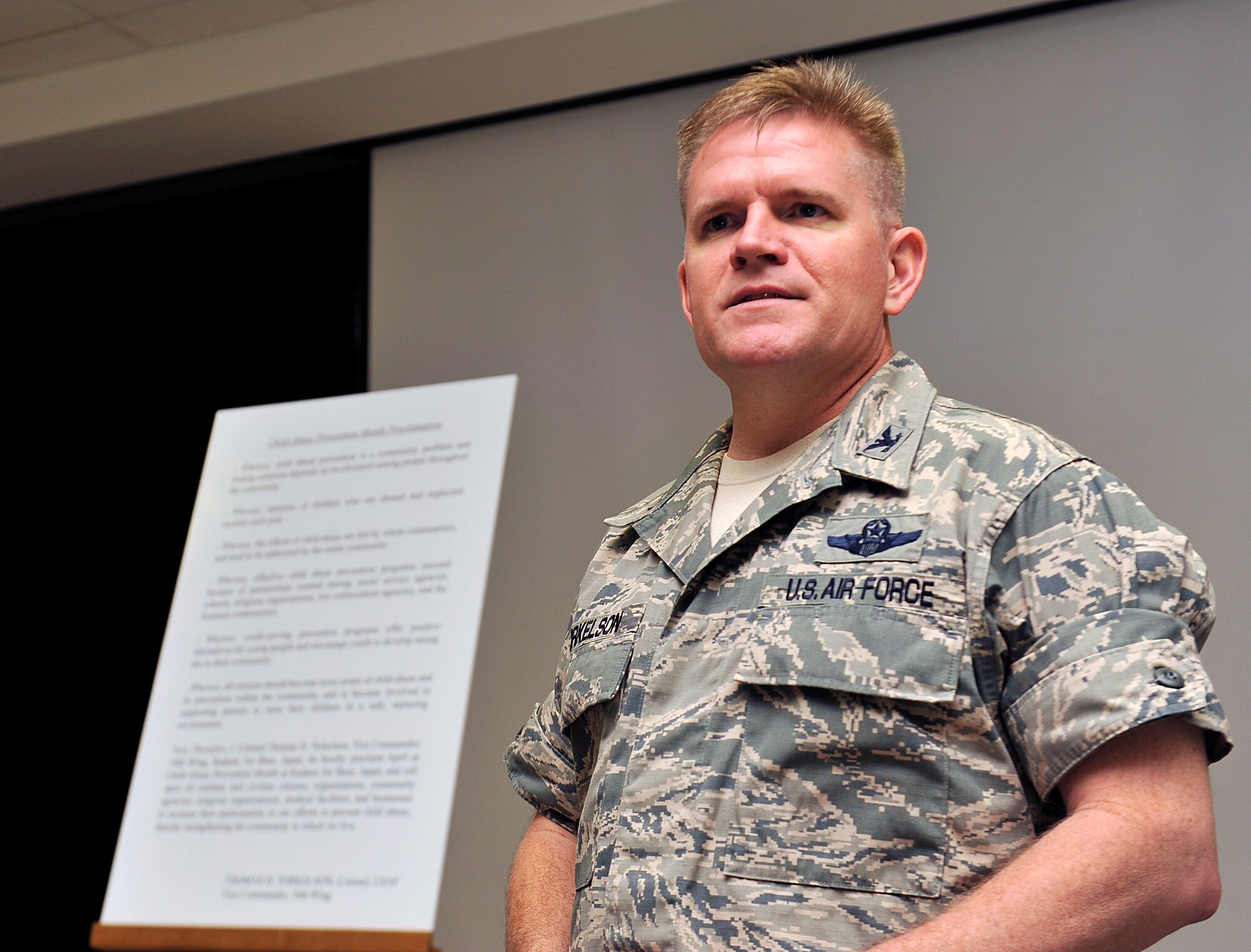 U.S. Air Force Col. Thomas Torkelson, 18th Wing vice commander, speaks about importance of child abuse prevention to an audience at the Schilling Community Center on Kadena Air Base, Japan, April 8, 2015. This year, Kadena's theme is "My Superhero Family." This April marks the 31st annual observance of National Child Abuse Prevention Awareness Month, a time dedicated to child abuse education, awareness and prevention activities. (U.S. Air Force photo by Naoto Anazawa)
