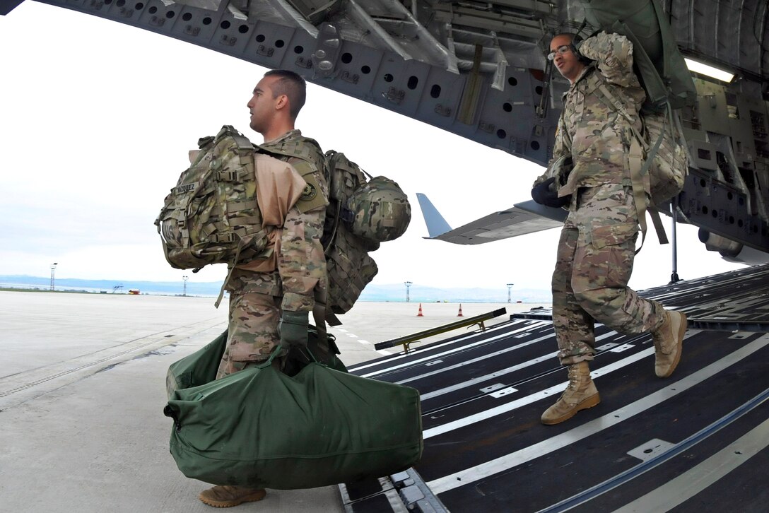 U.S. soldiers unload their baggage and equipment after landing at Burgas Airport in Burgas, Bulgaria, March 29, 2015. 