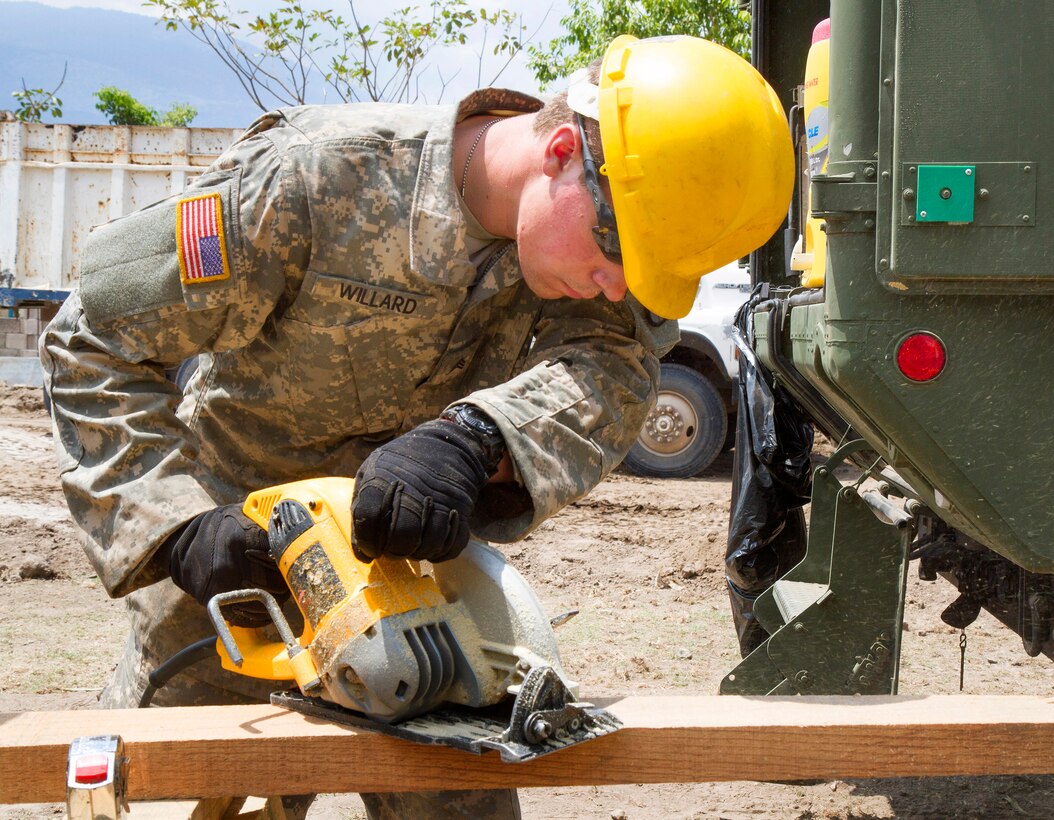 U.S. Army Sgt. Christopher D. Willard uses a power saw to cut off a piece of lumber at a school construction site during Beyond the Horizon 2015 in El Salvador, April 2, 2015. Willard is a carpentry and masonry specialist assigned to the 409th Engineer Company deployed from Fort Collins, Colo.