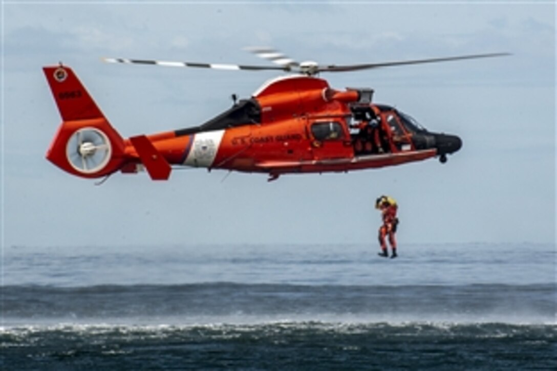 A Coast Guard rescue swimmer conducts a free fall direct deployment from an HH-65D Dolphin helicopter in the Pacific Ocean, April 7, 2015. The HH-65D Dolphin is assigned to Coast Guard Air Station Los Angeles.
