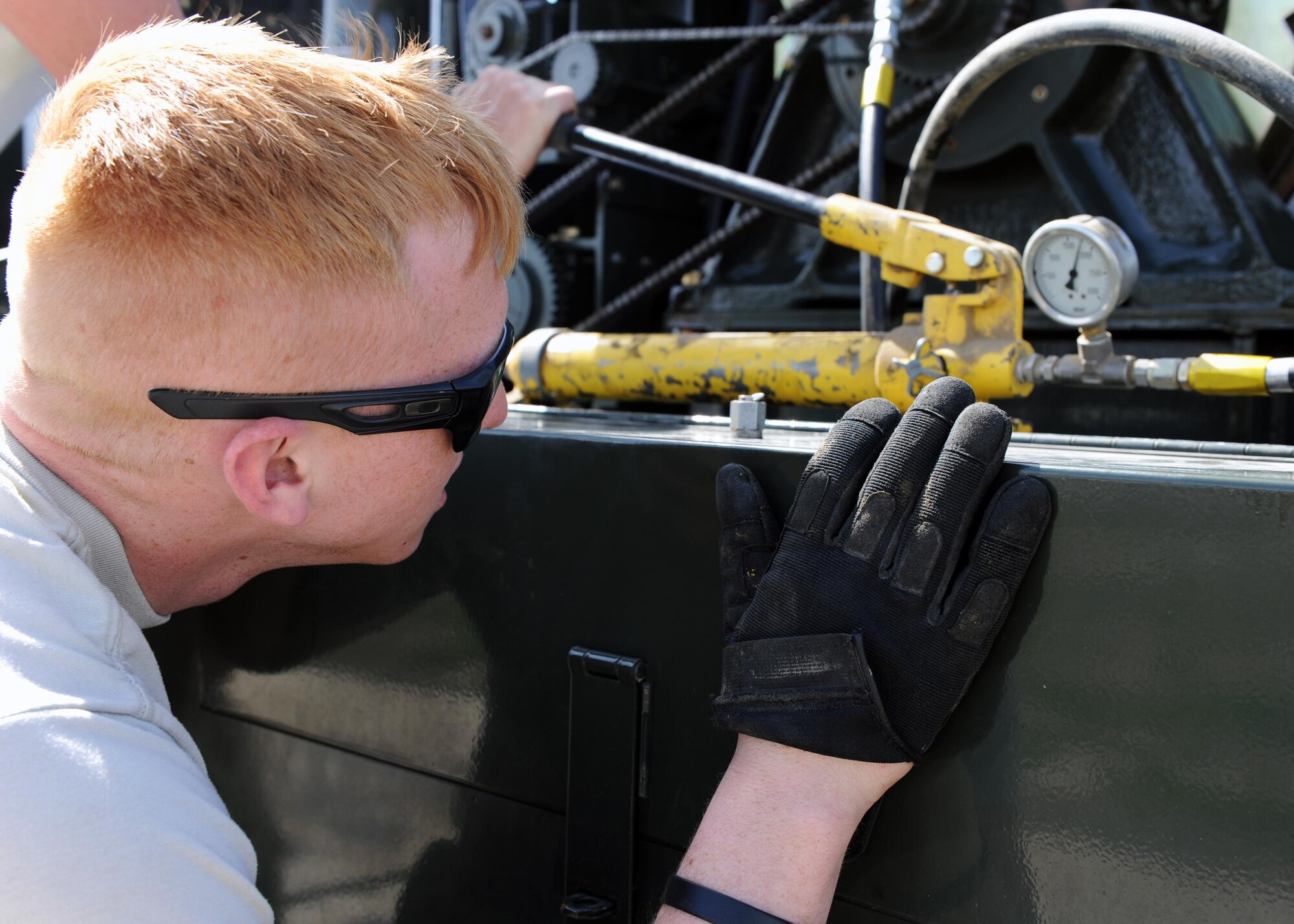 U.S. Air Force Senior Airman Bodin Rasbeck, 455th Expeditionary Civil Engineer Squadron power production journeyman, monitors a pressure gauge prior to testing a Mobile Aircraft Arresting System March 18, 2015 at Bagram Airfield, Afghanistan. The MAAS was from a separate taxiway as part of the construction of an alternate runway at Bagram. (U.S. Air Force photo by Staff Sgt. Whitney Amstutz/released)