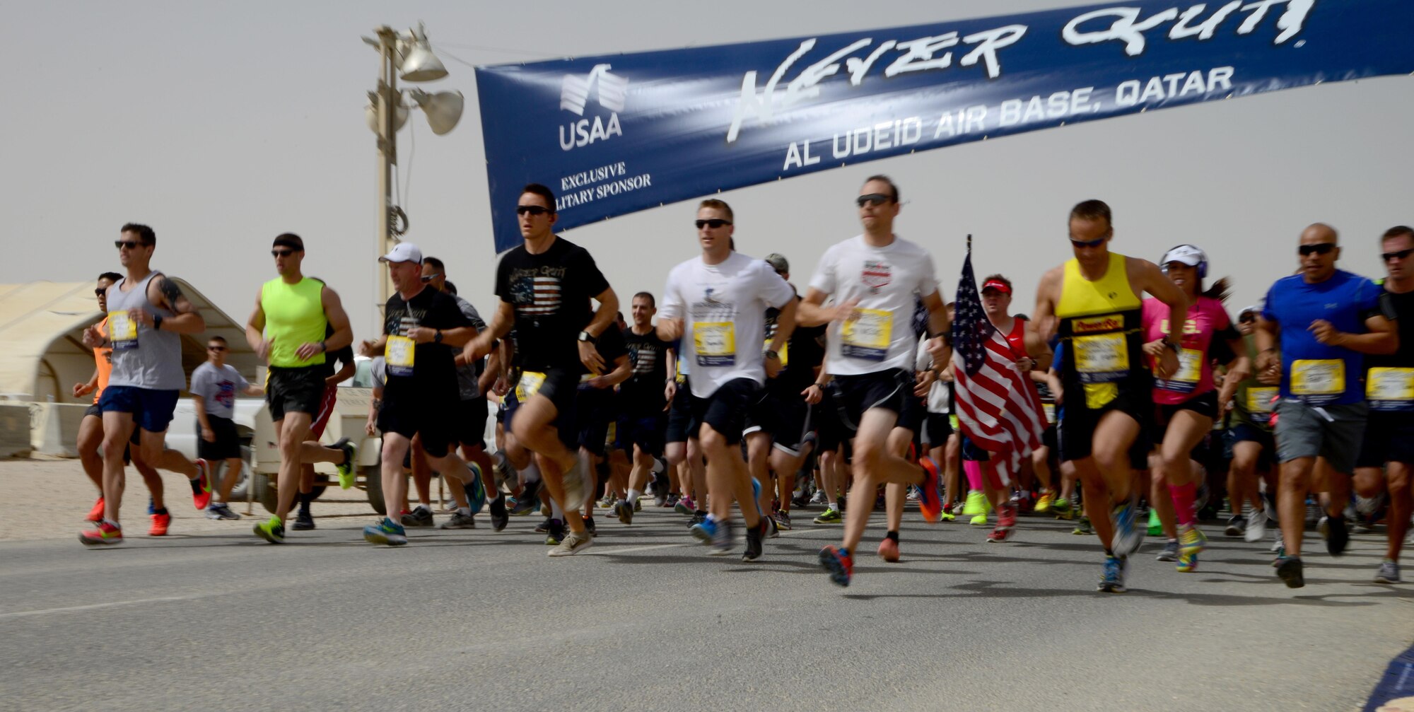 Participants of the 379th Air Expeditionary Wing’s Never Quit event begin the 5k run, April 4, 2015, at Al Udeid Air Base, Qatar. The event was coordinated by the 379th Expeditionary Force Support Squadron with informational booths provided by the 379th Expeditionary Medical Group, 379th Expeditionary Civil Engineer Squadron, and 379th AEW chapel services team. The purpose of the event was to encourage healthy and positive life choices. (U.S. Air Force photo by Senior Airman Kia Atkins)