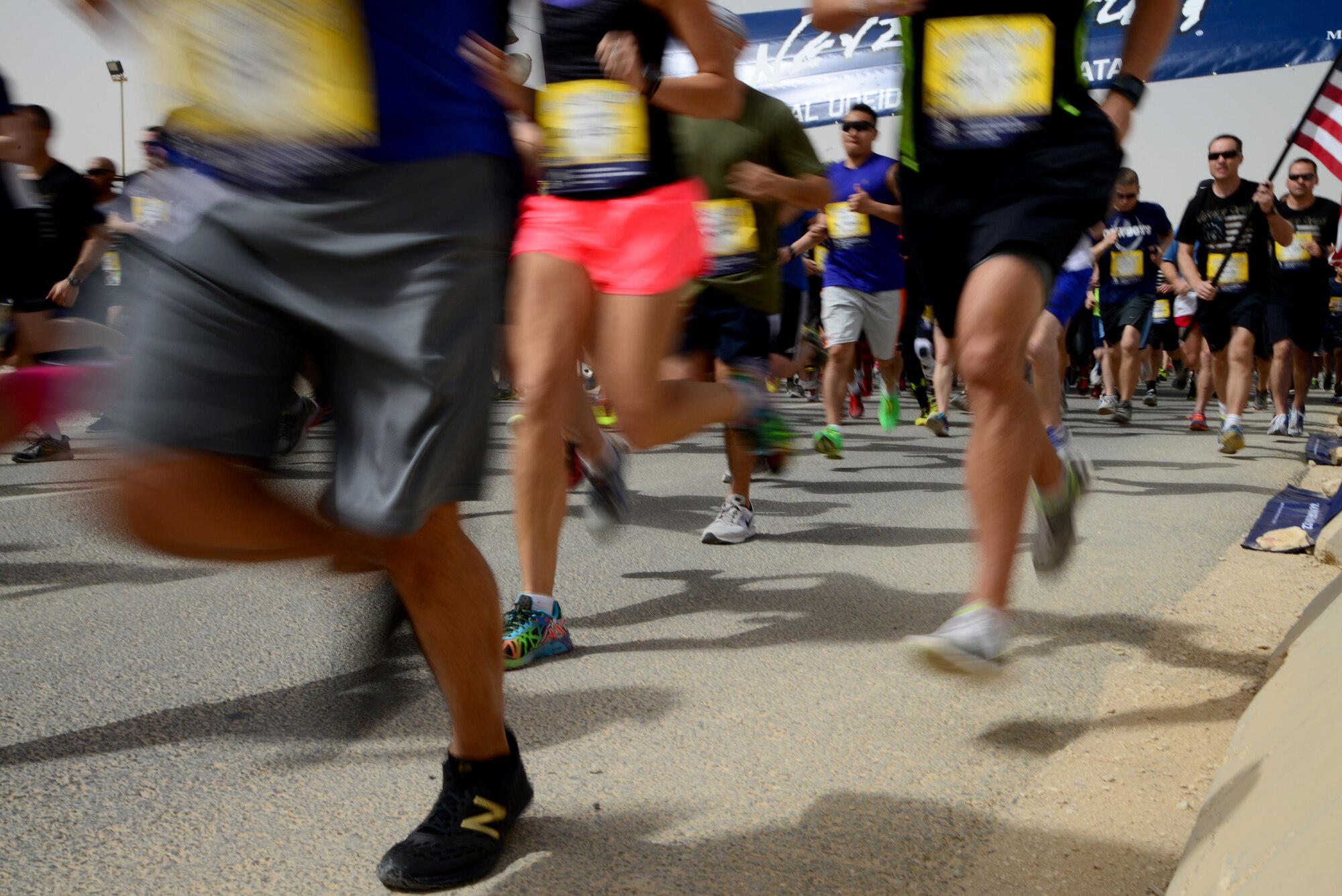 Participants of the 379th Air Expeditionary Wing’s Never Quit 5k run, April 4, 2015, at Al Udeid Air Base, Qatar. The event was coordinated by the 379th Expeditionary Force Support Squadron with informational booths provided by the 379th Expeditionary Medical Group, 379th Expeditionary Civil Engineer Squadron, and 379th AEW chapel services team. The purpose of the event was to encourage healthy and positive life choices. (U.S. Air Force photo by Senior Airman Kia Atkins)