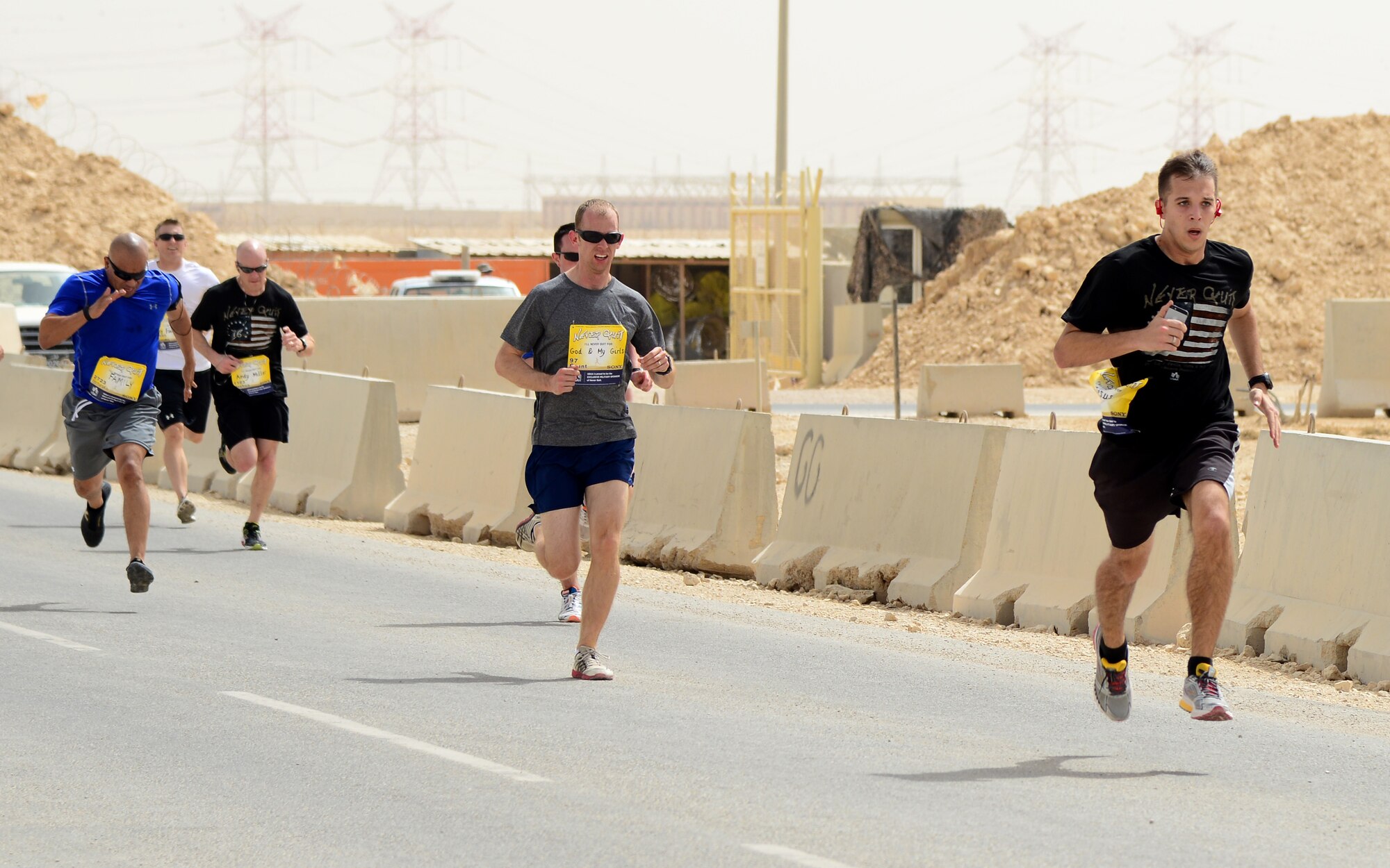 Participants of the 379th Air Expeditionary Wing’s Never Quit event run a 5k, April 4, 2015, at Al Udeid Air Base, Qatar. The event was coordinated by the 379th Expeditionary Force Support Squadron with informational booths provided by the 379th Expeditionary Medical Group, 379th Expeditionary Civil Engineer Squadron, and 379th AEW chapel services team. The purpose of the event was to encourage healthy and positive life choices. (U.S. Air Force photo by Senior Airman Kia Atkins)