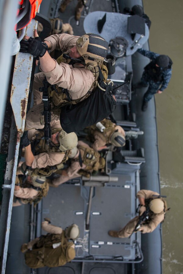U.S. Marines assigned to Force Reconnaissance Platoon, Maritime Raid Force, 26th Marine Expeditionary Unit (MEU) board a ship while conducting Visit, Board, Search, and Seizure (VBSS) training at Joint Base Langley-Eustis, Va., April 7, 2015. The exercise was part of the 26th MEU’s pre-deployment training, and allowed Marines to enhance their skills in maritime operations. (U.S. Marine Corps photo by Lance Cpl. Andre Dakis/26th MEU Combat Camera/Released)