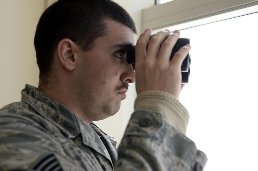 Staff Sgt. Matt, air traffic control liaison, scans the flightline from the air traffic control tower at an undisclosed location in Southwest Asia April 3, 2015. Air traffic controllers are like the referees or the safety observes in the sky. Matt is currently deployed from Tyndall Air Force Base, Fla. (U.S. Air Force photo/Tech. Sgt. Marie Brown/RELEASED)