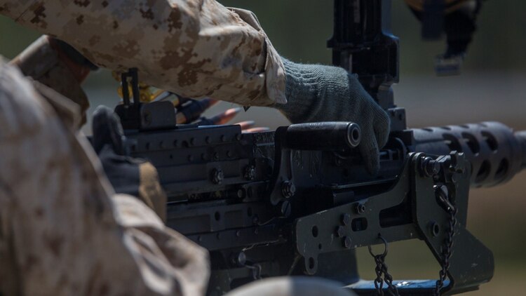 Marines with 2nd Combat Engineer Battalion load the M2 .50- caliber heavy machine gun during a range shoot at SR-7 aboard Camp Lejeune, N.C., April 6, 2015. Approximately 30 Marines from the battalion conducted a two-day, machine-gun range in which they shot the M249 Squad Automatic Weapon, the M240 Bravo medium machine gun, and the .50-caliber heavy machine gun from both the mounted and un-mounted positions at targets placed at unknown distances.