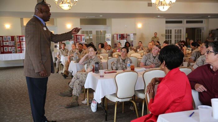 Female Marines look at brochures of information during the education fair at the fourth annual Vivian A. Holmes Female Marine Symposium at Marine Corps Air Station New River, North Carolina, March 26, 2015. During the symposium, female Marines received informational classes, participated in guided discussions and attended an education-station fair to get information on resources directly related to female Marines and their families.