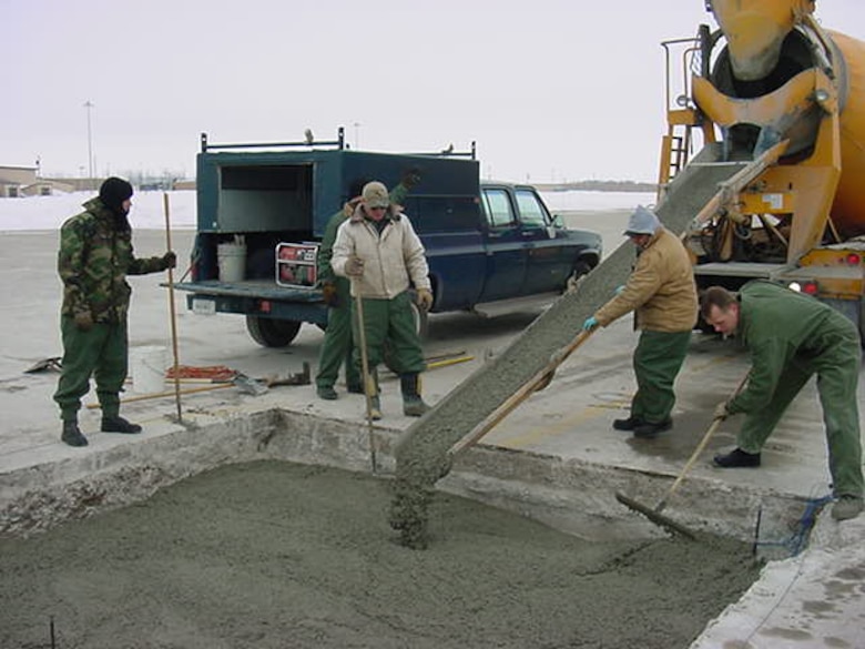 The US Air Force 319th Civil Engineering Squadron places antifreeze concrete during an airfield repair at Grand Forks Air Force Base, North Dakota, during February. Normal concrete would have required costly thermal protection.