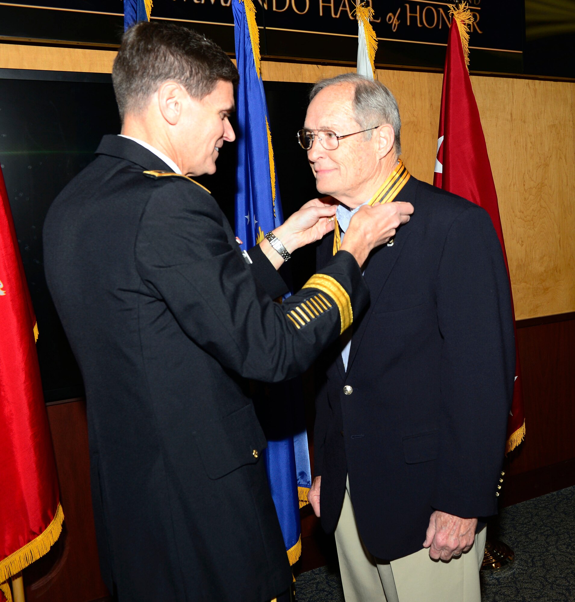 Retired Air Force Maj. Gen. James L. Hobson, Jr. receives the USSOCOM Commando Hall of Honor Medal from Army Gen. Joseph Votel, commander of USSOCOM, April 6, 2015 at the headquarters, MacDill Air Force Base, Fla. The command and special operations community gathered to honor nine individuals whose service spanned 70 years from World War II to Operation Enduring Freedom. The nine inductees for 2015 were Air Force Maj. Gen. (ret.) James L. Hobson, Jr., Army 1st Lt. Jack L. Knight, Air Force Col. (ret.) James Kyle, Command Sgt. Maj. (ret.) Richard Lamb, Marine Corps Lt. Col. (ret.) Terrence L. Moore, Marine Corps (ret.) John W. Ripley, Army Col. (ret.) Phillip R. Stewart, Army Col. (ret.) Lynn B. Stull, and Chief Warrant Officer Four (ret.) Paul A. Zeisman. Photo by Mike Bottoms, USSOCOM Public Affairs.