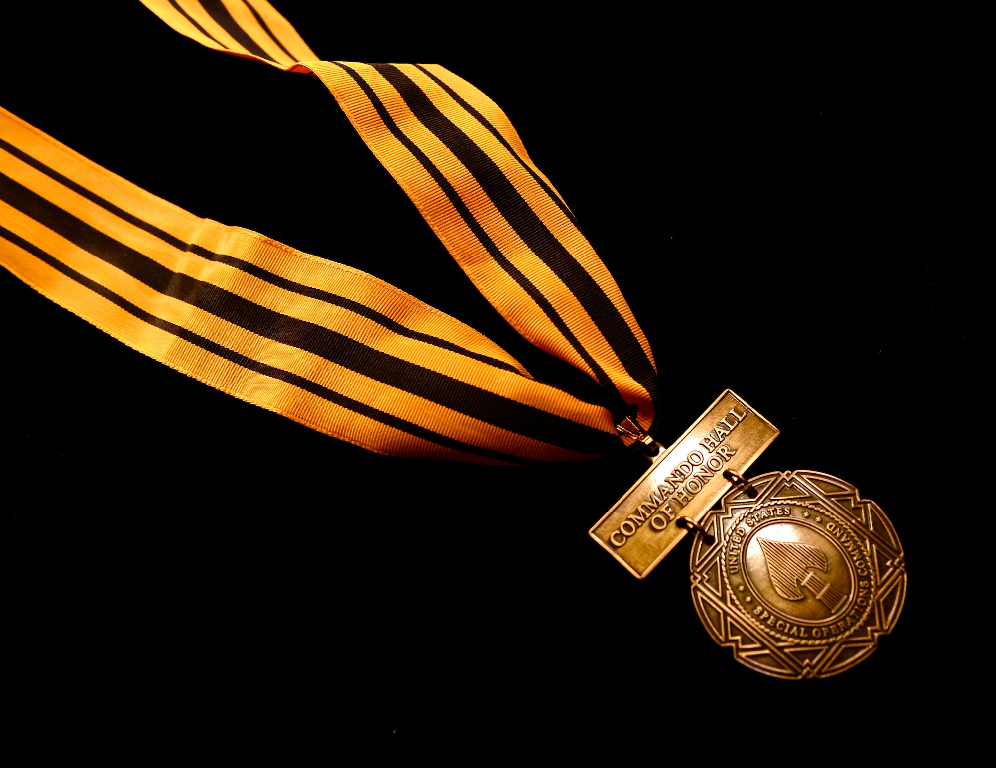 A U.S. Special Operations Command Commando Hall of Honor Medal is displayed during USSOCOM’s 2015 Commando Hall of Honor Induction ceremony held April 6, 2015, at the command's headquarters, MacDill Air Force Base, Fla. The command and special operations community gathered to honor nine individuals whose service spanned 70 years from World War II to Operation Enduring Freedom. (Photo by Mike Bottoms, USSOCOM Public Affairs.)
