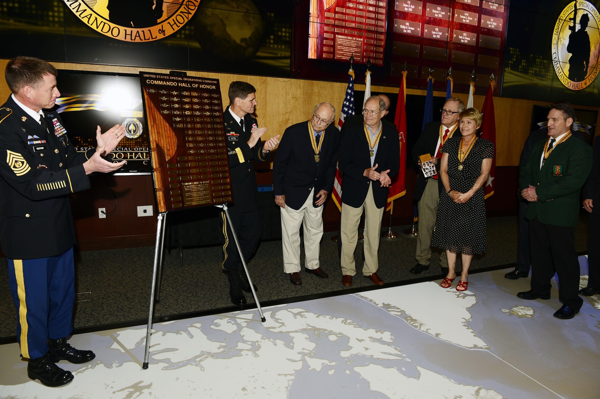 The Commando Hall of Honor plaque is unveiled at a ceremony honoring nine new U.S. Special Operations Command Hall of Honor inductees April 6, 2015, at the headquarters, MacDill Air Force Base Fla. The command and special operations community gathered to honor the nine former special operators whose service spanned 70 years from World War II to Operation Enduring Freedom.  (Photo by Mike Bottoms, USSOCOM Public Affairs)