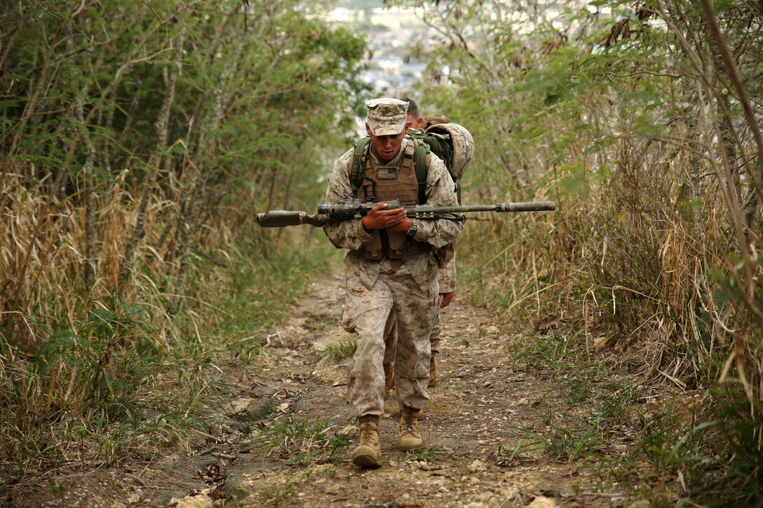 Lance Cpl. Ivan Trujillo, a scout with Weapons Company, 2nd Battalion, 3rd Marine Regiment, hikes up Ulupau Crater aboard Marine Corps Base Hawaii, April 8, 2015, before conducting high angle firing with his platoon. The Marines trained with high angle shooting, which is anything 30 degrees or greater between them and their target. (U.S. Marine Corps photo by Sgt. Sarah Dietz)
