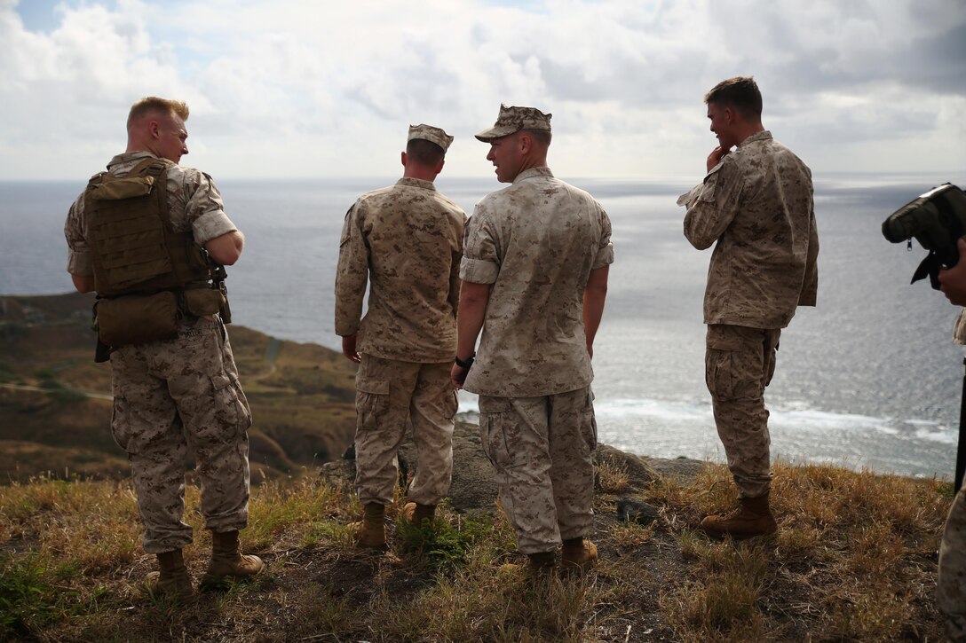 Marines with scout sniper platoon, Weapons Company, 2nd Battalion, 3rd Marine Regiment, rest at the top of Ulupau Crater at Range 10 aboard Marine Corps Base Hawaii after a hike up the crater, April 8, 2015. The Marines trained with high angle shooting, which is anything 30 degrees or greater between them and their target.
