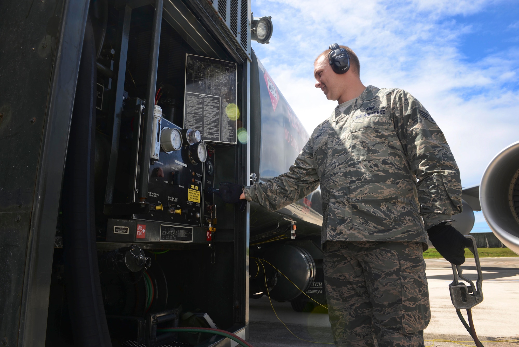 Senior Airman Jeffrey Reed, 36th Logistics Readiness Squadron fuels distribution operator, adjusts a fuel pump gauge April 8, 2015, at Andersen Air Force Base, Guam. More than 67 logistics readiness squadron Airmen work together in the fuels management flight to pump an average of 115,000 gallons of fuel per day. (U.S. Air Force photo by Senior Airman Katrina M. Brisbin/Released)