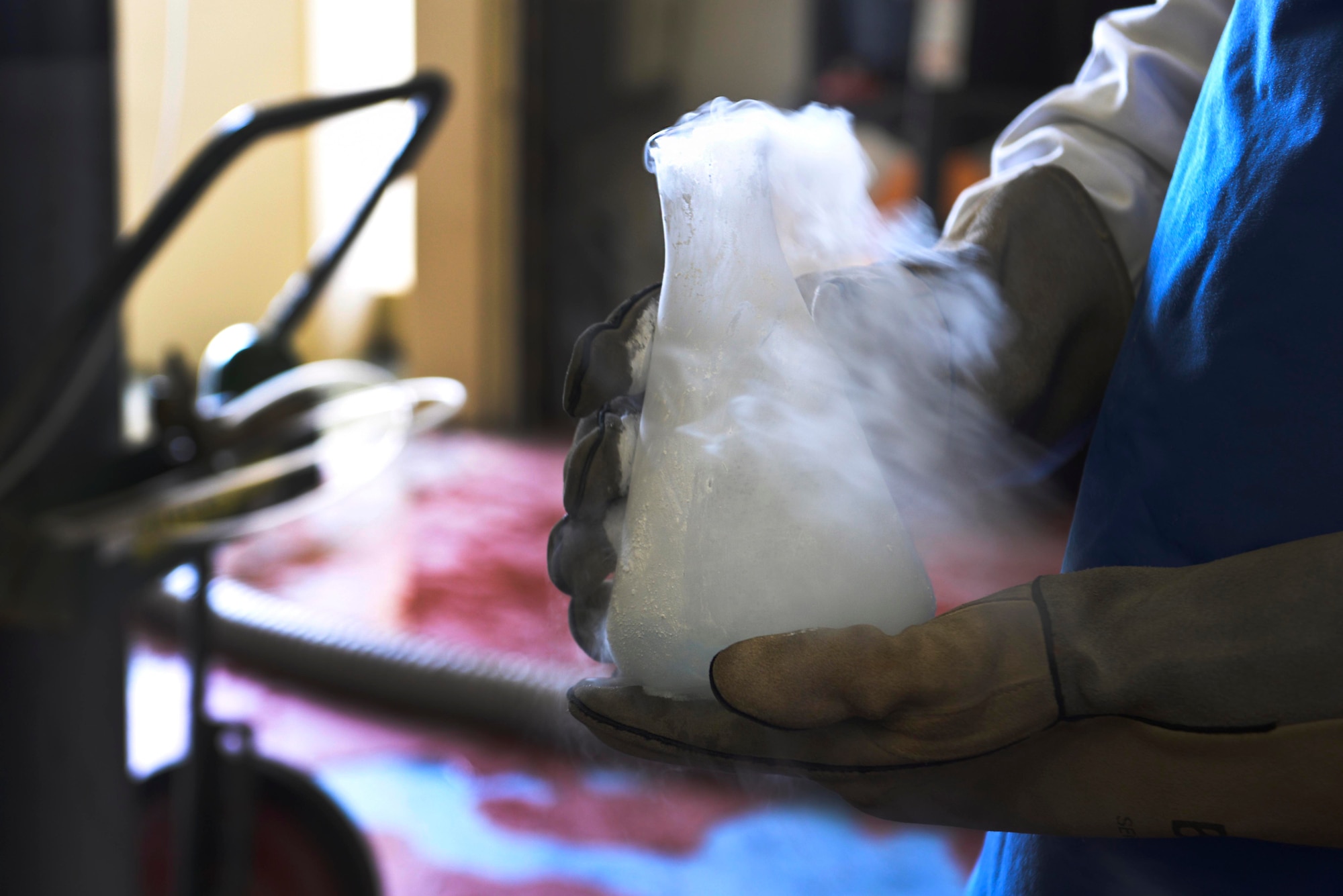Airman 1st Class Nathanael Markley, 36th Logistics Readiness Squadron cryogenic production technician, transports a sample of liquid oxygen that was pulled for testing April 8, 2015, at Andersen Air Force Base, Guam. Cryogenics Airmen produce liquid oxygen and nitrogen as well as gaseous oxygen and nitrogen. (U.S. Air Force photo by Senior Airman Katrina M. Brisbin/Released)