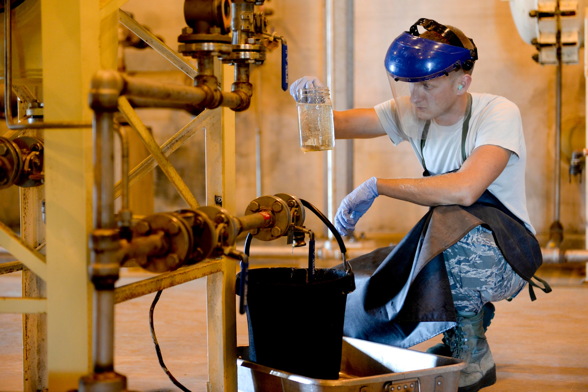 Airman 1st Class Steven Turner, 36th Logistics Readiness Squadron fuels facilities operator, inspects a sample of fuel April 8, 2015, at Andersen Air Force Base, Guam. Airmen perform daily checks to ensure clean and serviceable fuel is available for transient aircraft, helicopters and ground vehicles. (U.S. Air Force photo by Senior Airman Katrina M. Brisbin/Released)