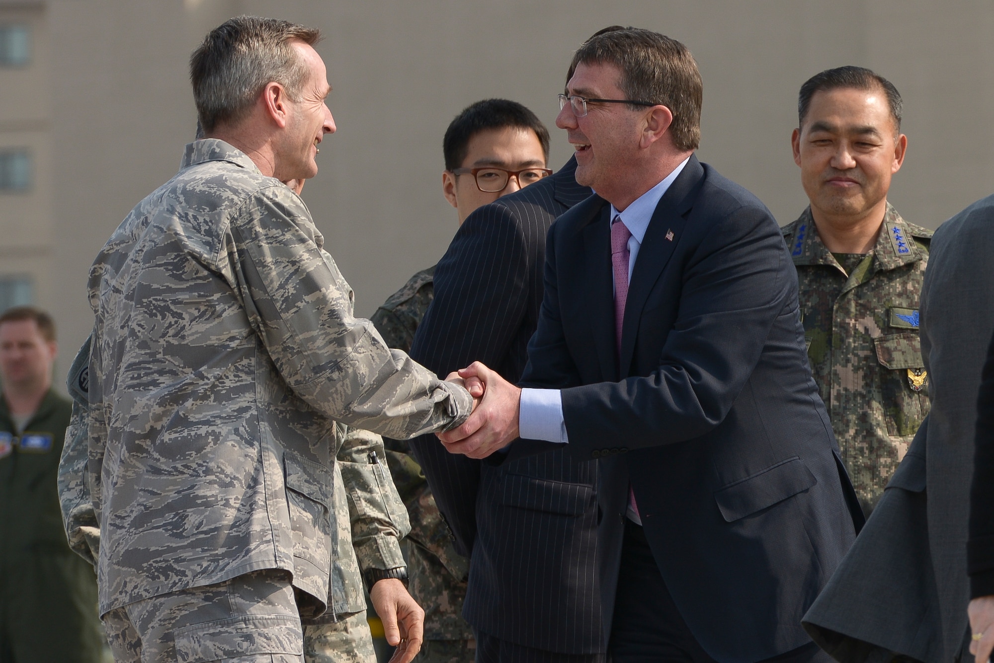 Secretary of Defense Ashton Carter is greeted by Lt. Gen. Terrence O'Shaugnessy April 9, 2015, at Osan Air Base, Republic of Korea. Carter was greeted by multiple Air Force, Army, and ROK leaders when arriving at the base.  (U.S. Air Force photo by Staff Sgt. Jake Barreiro/Released)