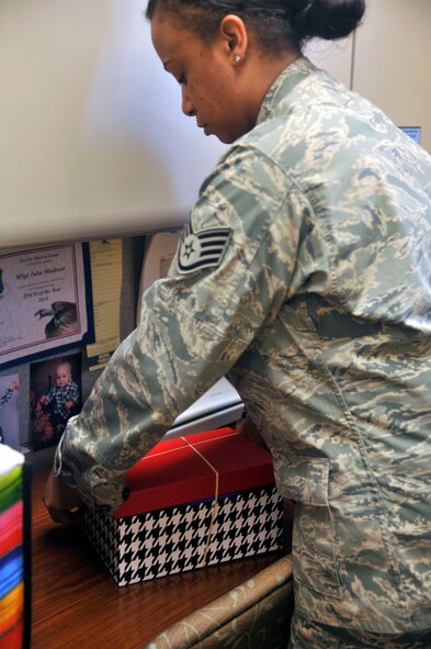 Staff Sgt. Sheminka Jordan, 92nd Medical Group dental records and reception NCO in charge, prepares a Welcome Box April 7, 2015, at Fairchild Air Force Base, Wash. Jordan along with other members of Fairchild collected more than 85 boxes to be donated to foster children. (U.S. Air Force photo/Airman 1st Class Taylor Bourgeous)
