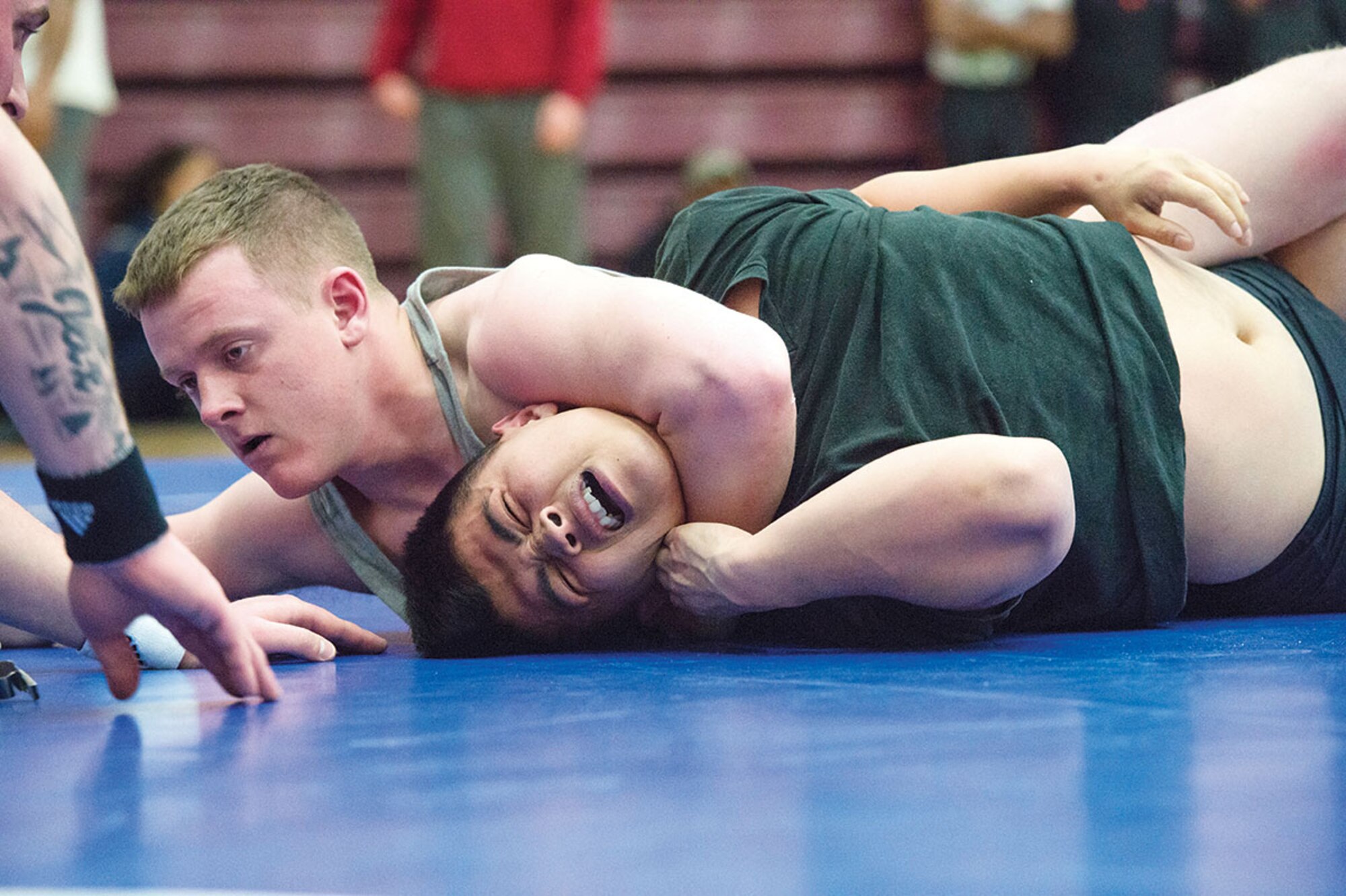 Pvt. Chris Poor, top, a native of Seymour, Tenn., assigned to 1st Squadron (Airborne), 40th Cavalry, attempts to pin Spc. Dai Le, a native of Modesto, Calif., assigned to 3rd Battalion (Airborne), 509th Infantry, during an intramural wrestling match on Joint Base Elmendorf-Richardson, Alaska, April 9, 2013. Poor did not pin Le but won the match based on points. (U.S. Air Force photo/Alejandro Pena)