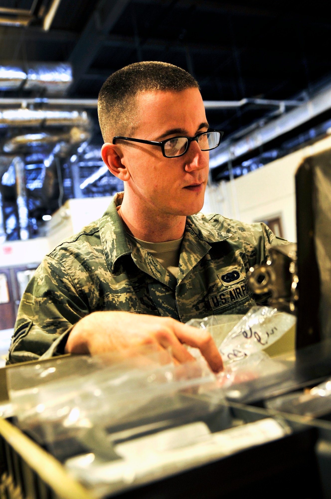 Airman 1st Class Zachery Deuyour, a 19th Logistics Readiness Squadron material management apprentice, verifies the shelf life of consumable parts in a MRSP March 9, 2015, at Little Rock Air Force Base, Ark. The inspection ensures the parts in stock meet technical order guidelines for use. (U. S. Air Force photo by Senior Airman Stephanie Serrano)