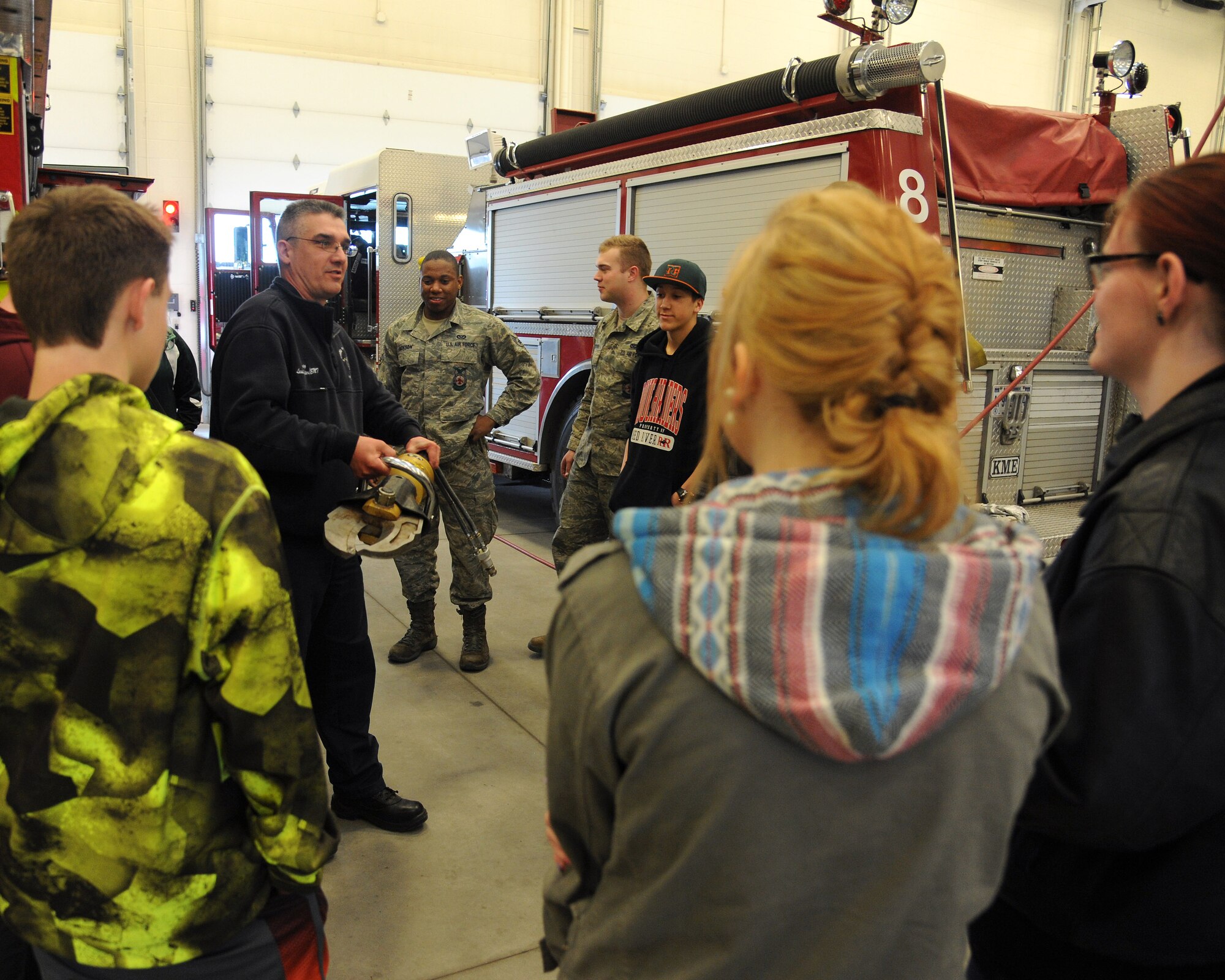James Mozey, 319th Civil Engineer Squadron Fire Department crew chief, shows local high school students what the “Jaws of Life” look like and what they can do Apr. 8, 2015, on Grand Forks Air Force Base, N.D. The fire department was one stop on the base tour held as part of the STEM (science, technology, engineering and mathematics) High School Career Forum. (U.S. Air Force photo by Senior Airman Zachiah Roberson/released)