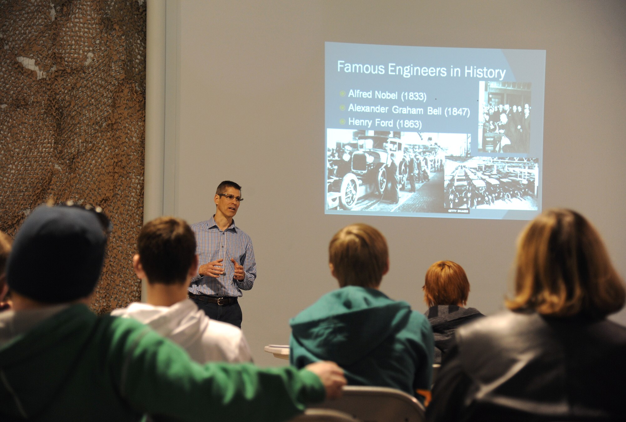 Bradley Painter, 319th Civil Engineer Squadron operations engineer, discusses the history of engineering and what engineer’s minds helped them to create with students from local private and public high schools Apr. 8, 2015, on Grand Forks Air Force Base, N.D. The visit was part of a STEM (science, technology, engineering and mathematics) program offered to high school students in the Grand Forks area. (U.S. Air Force photo by Senior Airman Zachiah Roberson/released)