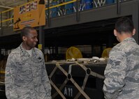 ALTUS AIR FORCE BASE, Okla. – U.S. Air Force Senior Airman Jereme Henson, 97th Logistics Readiness Squadron rigger, briefs U.S. Air Force Gen. Darren McDew, Air Mobility Command commander, on the air operations mission at Altus AFB, April 8, 2015. Henson explained the many different types of cargo they load and the process of mending and preparing parachutes. (U.S. Air Force photo by Airman 1st Class Nathan Clark/Released)