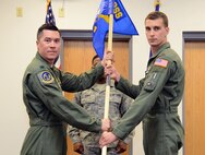 Lt. Col. James Blanchard, left, 582nd Operations Support Squadron commander, passes the 582nd OSS, Detachment 4, guidon to Maj. Bryant Bevan , 582nd OSS, Det. 4 commander, during an assumption of command ceremony at Malmstrom Air Force Base April 7, 2015. The 582nd OSS will report to the first ever Air Force helicopter group that was activated March of this year at 20th Air Force. (U.S. Air Force photo/ Airman 1st Class Dillon Johnston)