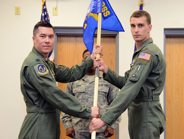 Lt. Col. James Blanchard, left, 582nd Operations Support Squadron commander, passes the 582nd OSS, Detachment 4, guidon to Maj. Bryant Bevan , 582nd OSS, Det. 4 commander, during an assumption of command ceremony at Malmstrom Air Force Base April 7, 2015. The 582nd OSS will report to the first ever Air Force helicopter group that was activated March of this year at 20th Air Force. (U.S. Air Force photo/ Airman 1st Class Dillon Johnston)