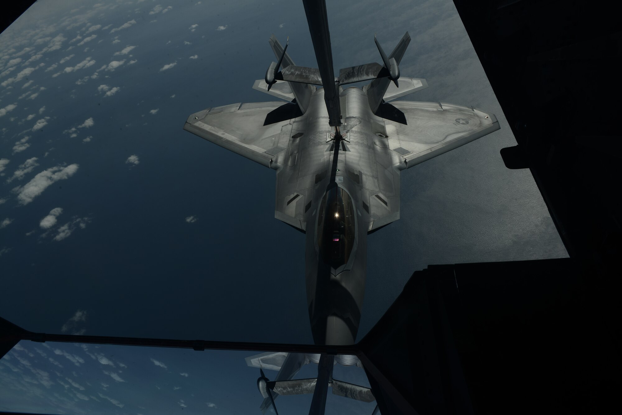 An F-22 Raptor receives fuel from a KC-10 Extender during an Advanced Combat Operations Training over the Atlantic Ocean, March 19, 2015. The KC-10 can hold up to 356,000 pounds of fuel and can refuel aircraft from all branches of the U.S. military. (U.S. Air Force photo by Airman 1st Class Joshua King/Released)