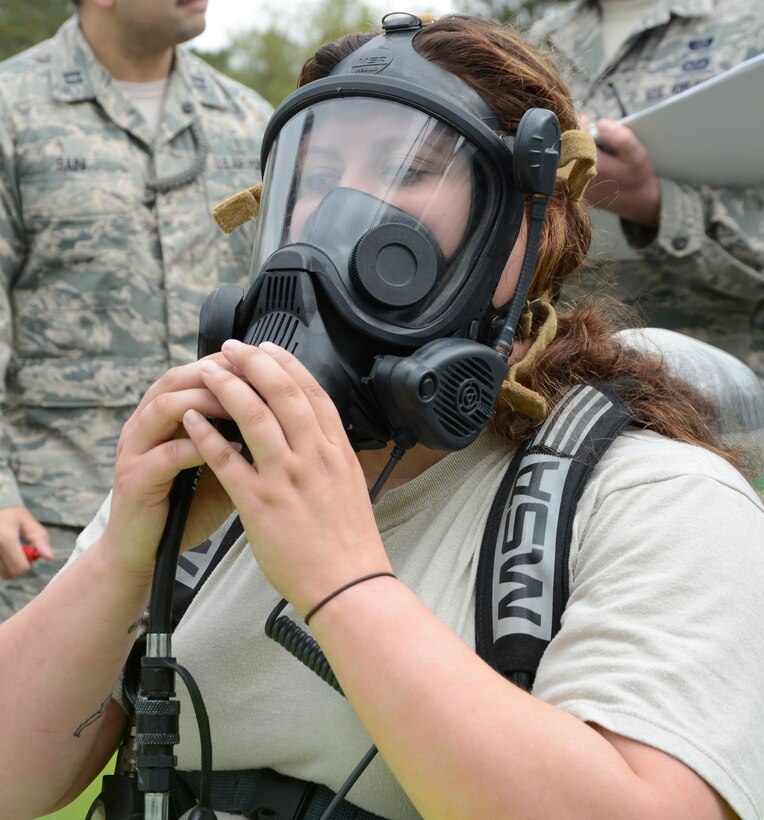 Senior Airman Skyler Miller, 78th Aerospace Medicine Squadron Bioenvironmental engineer journeyman, tests her gas mask at the start of a chlorine response field training exercise at Warrior Air Base March 27. The goal of the exercise was to test teamwork skills and processes during a simulated emergency. (U.S. Air Force photo by Ed Aspera)