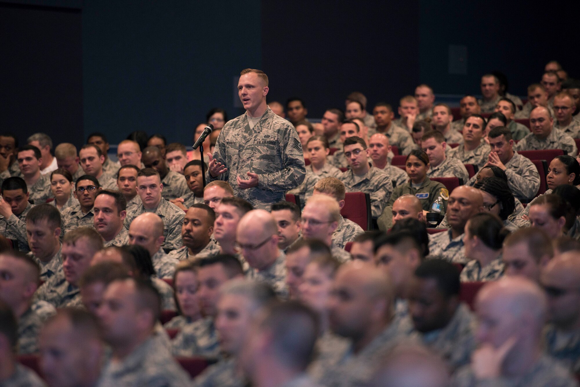 U.S. Air Force Airmen ask questions during an all-call with Chief Master Sgt. of the Air Force James A. Cody at Sheppard Air Force Base, Texas, April 8, 2015. Cody and his wife, retired Chief Master Sgt. Athena Cody, toured Sheppard to meet with Airmen, thank them for what they do and answer their questions. The all-call provided Airmen with knowledge about retirement benefits, force reduction, feedback and enlisted performance reports, capstone week and other mentorship topics. (U.S. Air Force photo by Senior Airman Kyle Gese/Released)