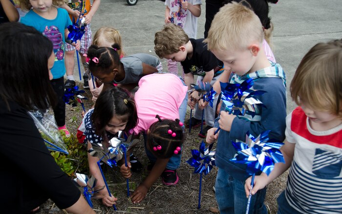 Children plant pinwheels on April 8, 2015 at the Karen Scott Heath Child Development Center on Joint Base Charleston – Weapons Station, S.C. Pinwheel gardens represent the effort to focus on community activities that support families and public policies prioritizing prevention of child abuse and neglect.  (U.S. Air Force photo/Staff Sgt. AJ Hyatt)