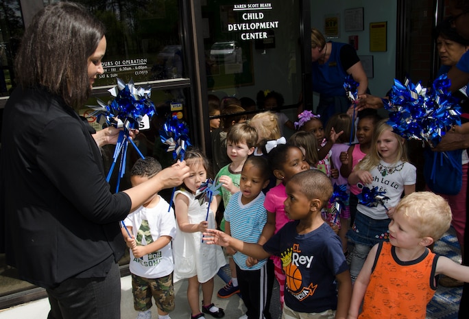 Brenda Edmond, 628th Medical Group Family Advocacy Outreach Program manager, hands out pinwheels to children April 8, 2015 at the Karen Scott Heath Child Development Center on Joint Base Charleston – Weapons Station, S.C. The pinwheels are a symbol for child abuse prevention and intended to be an uplifting reminder of childhood and the bright future children deserve. (U.S. Air Force photo/Staff Sgt. AJ Hyatt)
