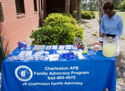 Jennifer Green, 628th Medical Group Family Advocacy Treatment Manager/Social Worker, sets up a table to distribute Child Abuse Prevention Month information on April 8, 2015 at the Karen Scott Heath Child Development Center on Joint Base Charleston – Weapons Station, S.C. Each year in April, the President of the United States issues a proclamation to announce National Child Abuse Prevention Month. Many State Governors also issue proclamations encouraging public awareness of child abuse and neglect, recommitting state resources to the cause and promoting community involvement through state and local activities. (U.S. Air Force photo/Staff Sgt. AJ Hyatt)