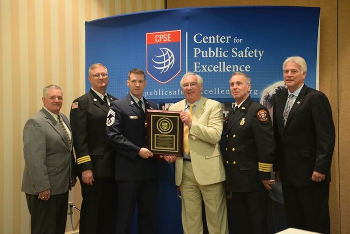 Glenn Easterby, Joint Base Charleston deputy fire chief; Greg Russell, JB Charleston assistant fire chief; Chief Master Sgt. David Rose, JB Charleston fire chief; Steve Westermann, Center for Public Safety Excellence, Inc., chairman; James Copeland, JB Charleston deputy fire chief; and Jim Podolski, Air Force fire chief,  pose with the plaque the  JB Charleston Fire Department earned when the Commission on Fire Accreditation International panel approved their accreditation at the Caribe Royale Hotel and Convention Center near Orlando, Fla., March 15, 2015.    (U.S. Air Force photo/Tech. Sgt. Mike Meares) 