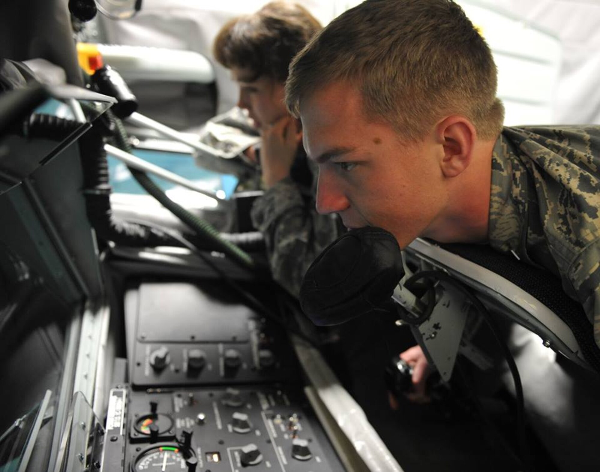 U.S. Air Force Academy cadets C2C Veronica Morthorpe, left, and C3C Alec Hubbard, right, from Squadron 22 learn how to use the KC-135 Boom Operator Weapons System Trainer while on a visit to McConnell Air Force Base, Kan., April 3, 2015. The 22nd Air Refueling Wing is the sponsor base of the 22nd Squadron at the Academy, cadets from all four classes came to McConnell to get first-hand experience in the operational Air Force. (U.S. Air Force photos by 2nd Lt Krystal Jimenez)