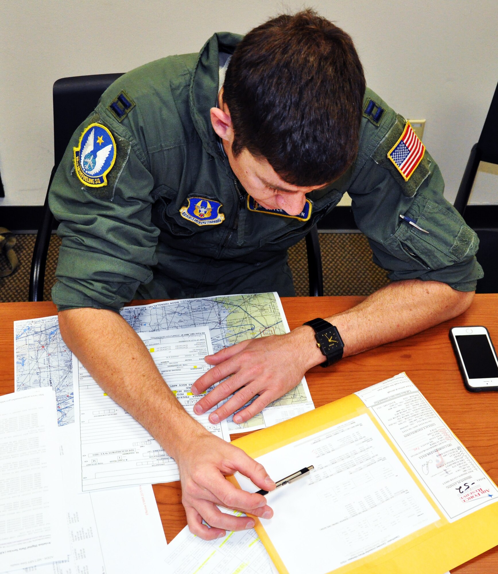 Capt. Bryce Sager, a pilot assigned to the Air Force Reserve 18th Air Refueling Squadron, 931st Air Refueling Group, McConnell Air Force Base, Kan., reviews mission plans, April 8, 2015.  Aircrew members meet several hours before departure to review the mission as well as go over contingency plans and safety briefings.  Sager was part of an aircrew made up of Reservists who were preparing to operate a KC-135 Stratotanker on an air refueling exercise, during which they refueled a B-52 Statofortress assigned to Barksdale Air Force Base, La.  (U.S. Air Force photo by Capt. Zach Anderson)