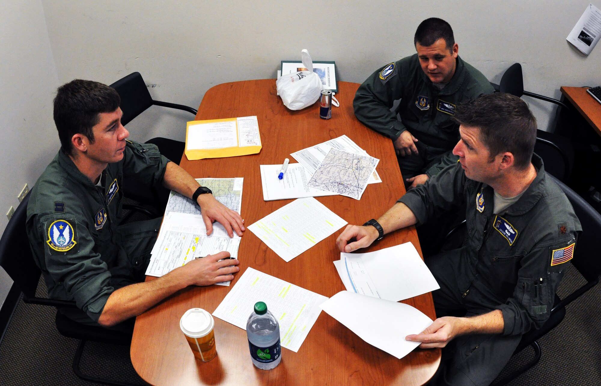 Pilots Capt. Bryce Sager, Maj. Jason Helmick and refueling boom operator Master Sgt. Aaron Meadows, all members of the Air Force Reserve 18th Air Refueling Squadron, 931st Air Refueling Group, McConnell Air Force Base, Kan., conduct mission planning and pre-flight briefings, April 8, 2015.  Aircrew members meet several hours before departure to review the mission as well as go over contingency plans and safety briefings.  The three aircrew members were preparing to operate a KC-135 Stratotanker on an air refueling exercise, during which they refueled a B-52 Statofortress assigned to Barksdale Air Force Base, La.  (U.S. Air Force photo by Capt. Zach Anderson)